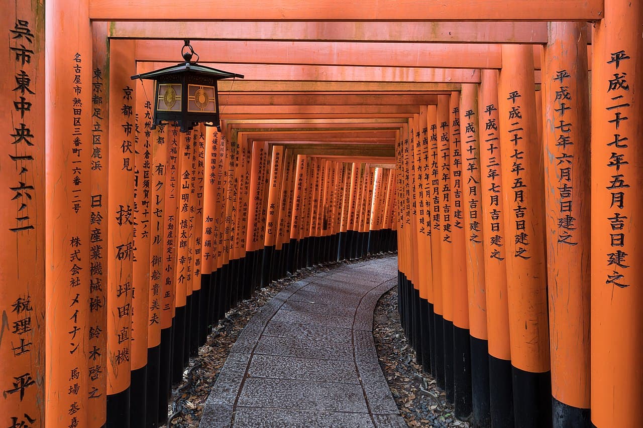 Vermilion torii gates lining a path at Fushimi Inari, Kyoto