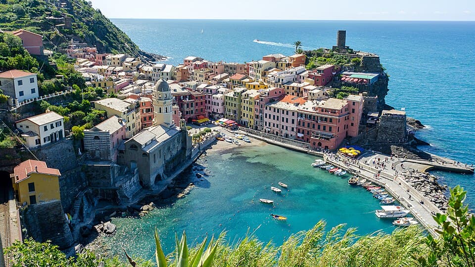Colorful clifftop village above a Mediterranean harbor